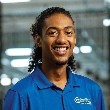 Headshot of Aziz Gram Sarhan Jr. wearing a blue shirt